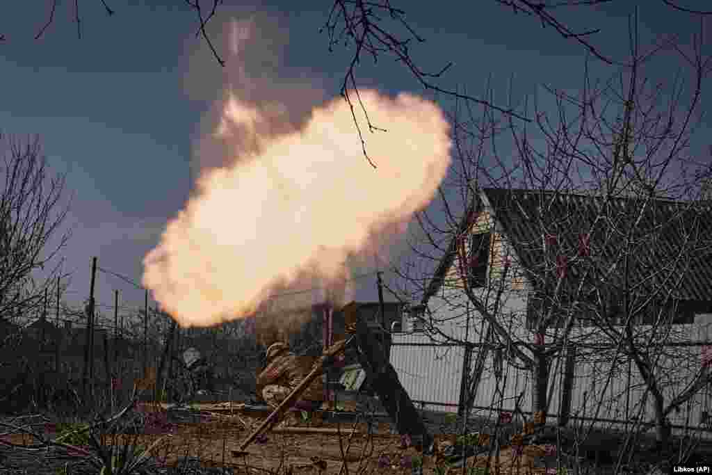 Ukrainian soldiers fire a mortar at Russian positions. The battle for Bakhmut has been called the "meat grinder" due to the violent and bloody artillery duels and infantry assaults.