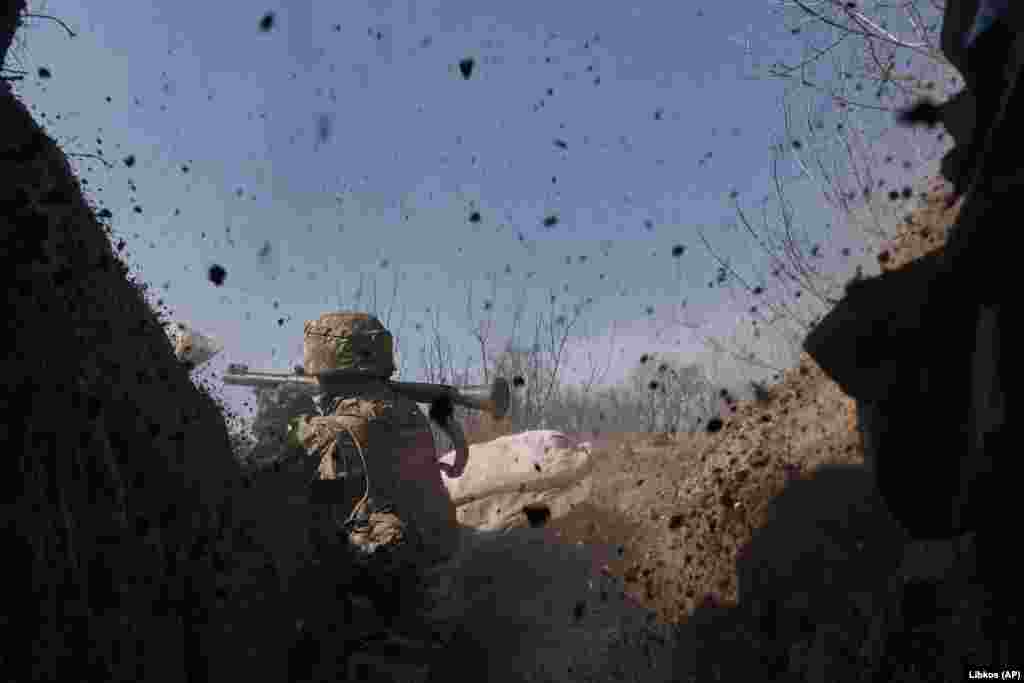 A Ukrainian soldier of the 28th Brigade fires a grenade toward Russian positions. Russia, which refers to Bakhmut by its Soviet-era name of Artyomovsk, says that capturing the city is vital to completing the capture of the Donbas industrial region, one of its main war goals. 