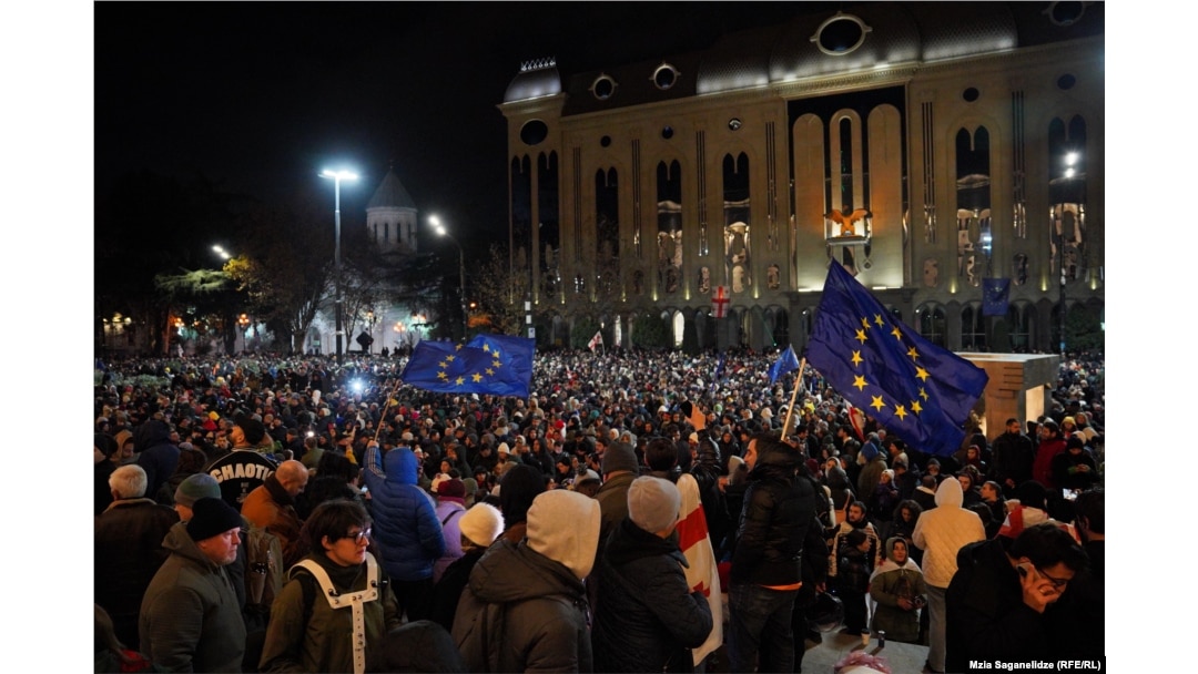 Protesters rally outside the parliament building in Tbilisi on November 28.