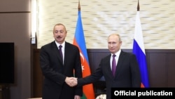 Russian President Vladimir Putin shakes hands with Azerbaijani President Ilham Aliyev during their meeting in Moscow, Russia, Sept. 1, 2018