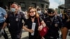 Russian police officers in Moscow detain a supporter of Ivan Safronov, a former journalist who was detained on "treason" charges earlier this week. 