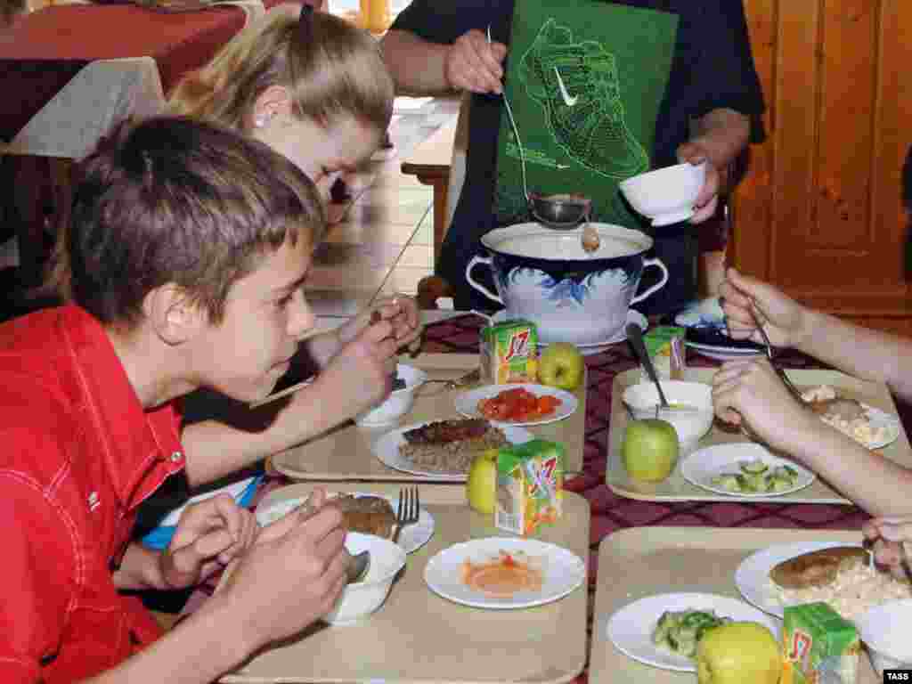 Russian schoolchildren eating a school lunch (ITAR-TASS). - Providing at least one hot meal a day at school improves learning and can be a powerful incentive for parents in poor areas to send their children to school regularly. Plan B includes $3 billion a year to provide school lunches for every child who needs one. "Sick children often face a lifetime of diminished productivity because of interruptions in schooling together with cognitive and physical impairment," says economist Jeffery Sachs.