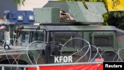 A U.S. member of the NATO-led Kosovo Force (KFOR) stands guard near a municipal building in Leposavic, northern Kosovo, on May 31. 