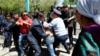 Полицейские и сотрудники специального подразделения задерживают собравшихся участвовать в земельном митинге. Алматы, 21 мая 2016 года.