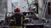 Firefighters work at the site of buildings damaged during Russian drone and missile strikes in Lviv, July 12, 2025.